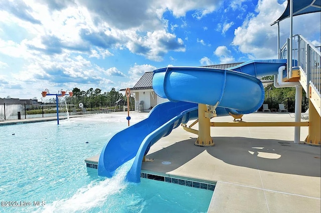 exterior space featuring a water slide and fence