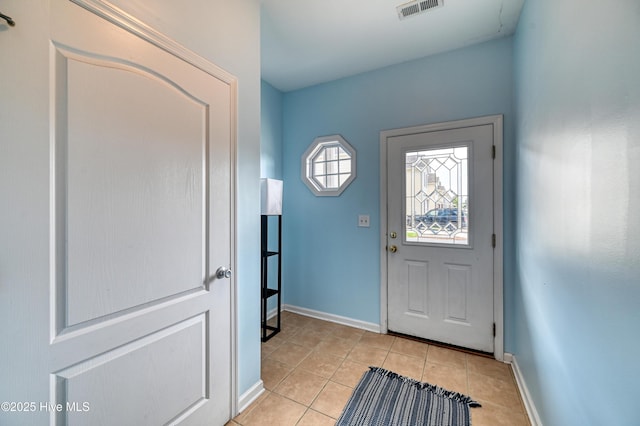 entryway with light tile patterned flooring