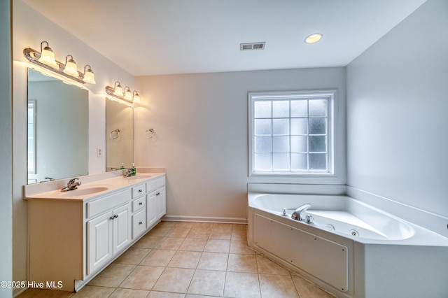 bathroom with tile patterned flooring, vanity, and a tub to relax in