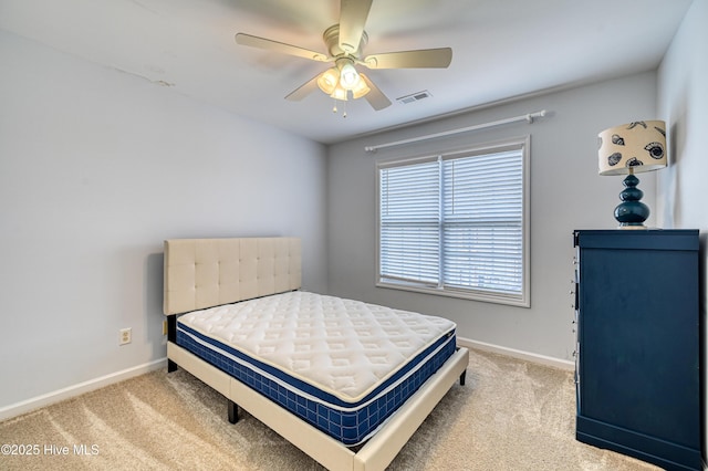 bedroom with ceiling fan and light carpet