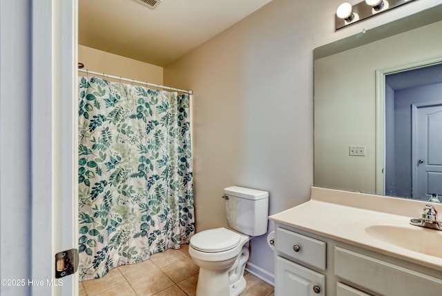 bathroom with vanity, tile patterned floors, and toilet