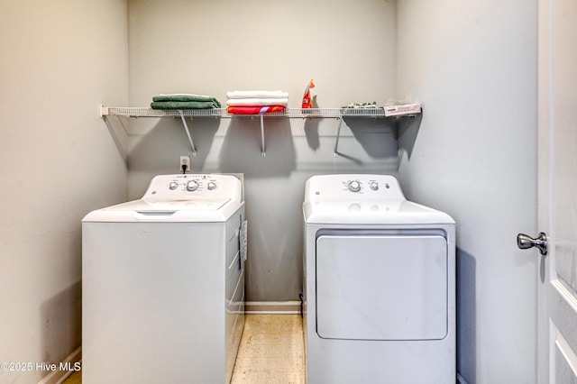 washroom with washing machine and clothes dryer