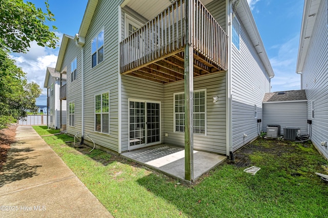 exterior space with a patio, a yard, and cooling unit