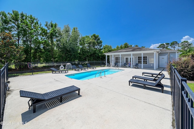 view of pool with an outbuilding and a patio area