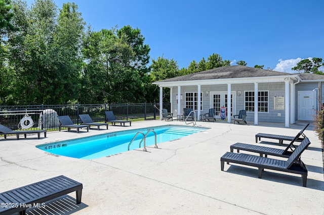 view of swimming pool featuring an outdoor structure and a patio area