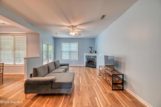 living room featuring ceiling fan and light hardwood / wood-style floors