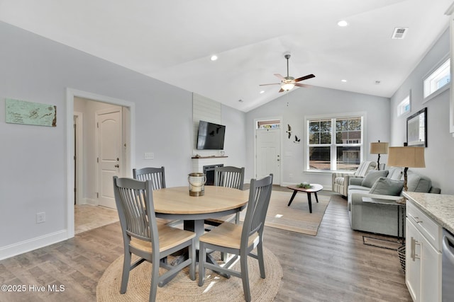 dining area with vaulted ceiling, light hardwood / wood-style flooring, and a wealth of natural light