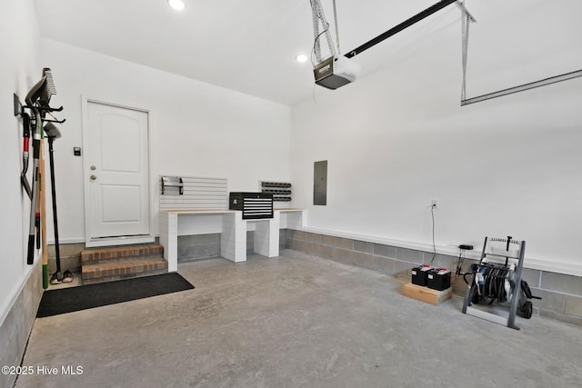 garage with a garage door opener and electric panel