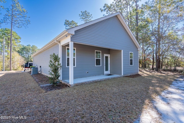 view of front of property with a patio and central air condition unit