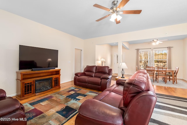 living room featuring hardwood / wood-style floors and ceiling fan