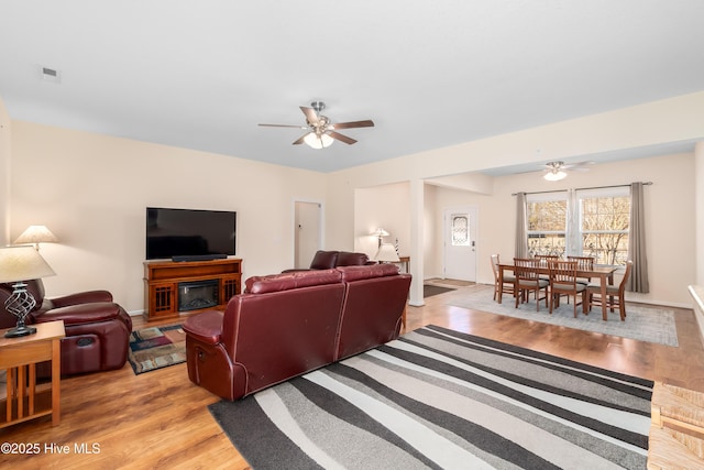 living room with ceiling fan and light hardwood / wood-style floors