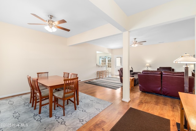 dining space featuring ceiling fan, beam ceiling, and light hardwood / wood-style floors