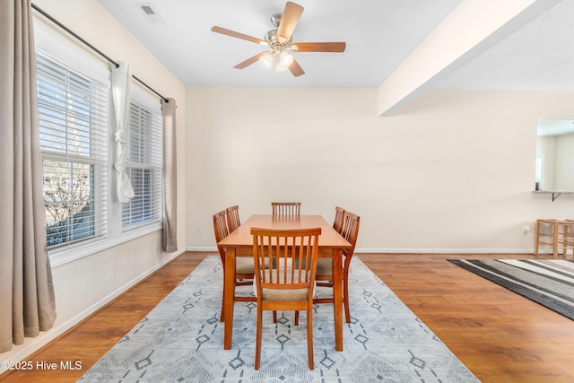 dining room with hardwood / wood-style floors and ceiling fan