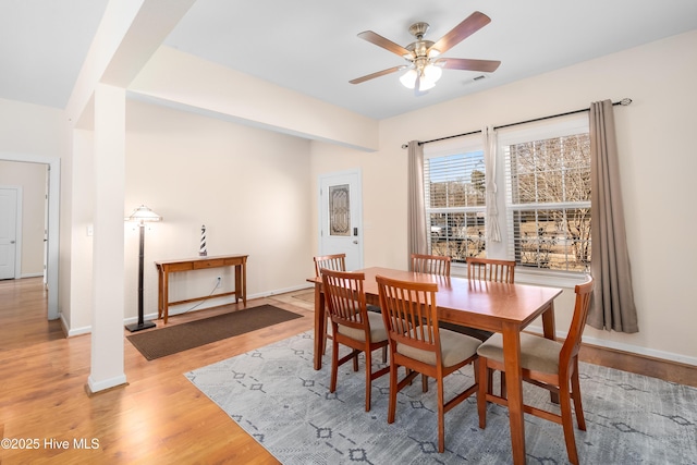 dining room with light hardwood / wood-style floors and ceiling fan