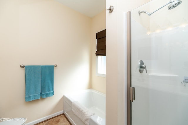 bathroom featuring tile patterned floors and shower with separate bathtub