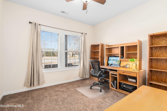 carpeted office space featuring ceiling fan