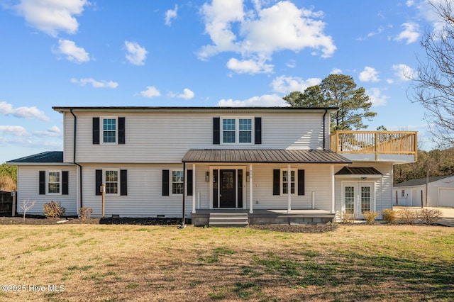 view of front facade with a front yard, crawl space, covered porch, and a balcony