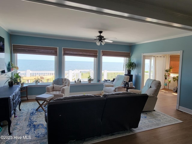 living room featuring a water view, ceiling fan, ornamental molding, and wood-type flooring