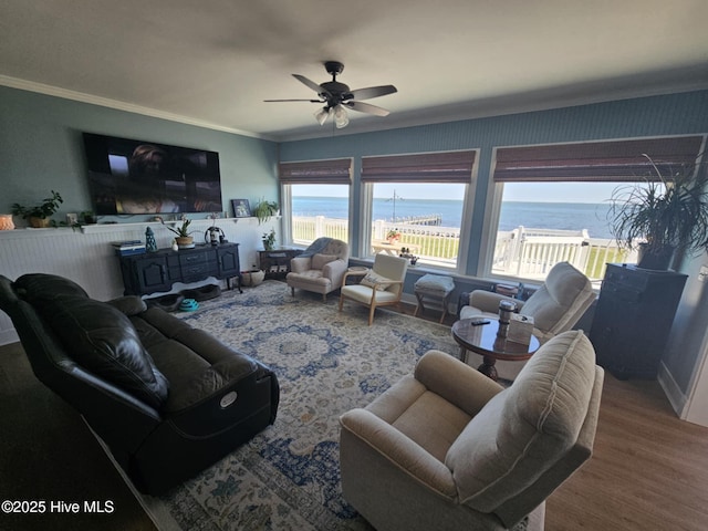 living room featuring hardwood / wood-style floors, crown molding, and ceiling fan