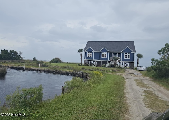 view of front of property with a water view