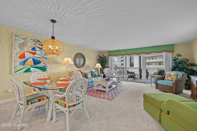 dining space with carpet flooring and a chandelier