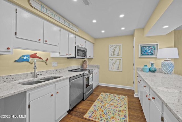 kitchen featuring sink, stainless steel appliances, light stone countertops, white cabinets, and dark hardwood / wood-style flooring