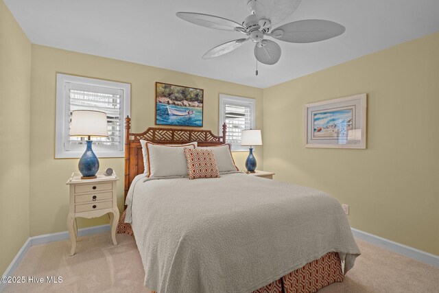 bedroom featuring ceiling fan and light carpet