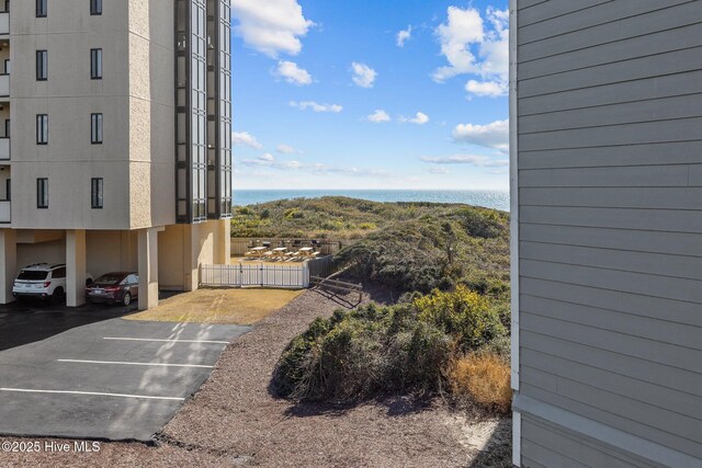 exterior space with a carport and a water view