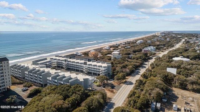 birds eye view of property with a water view and a beach view