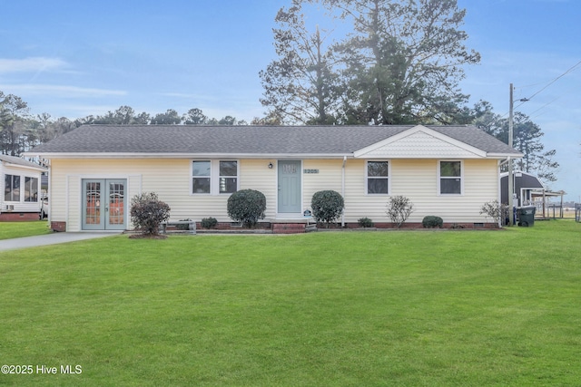 ranch-style house with a front lawn and french doors