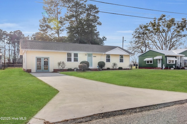 single story home with french doors and a front yard