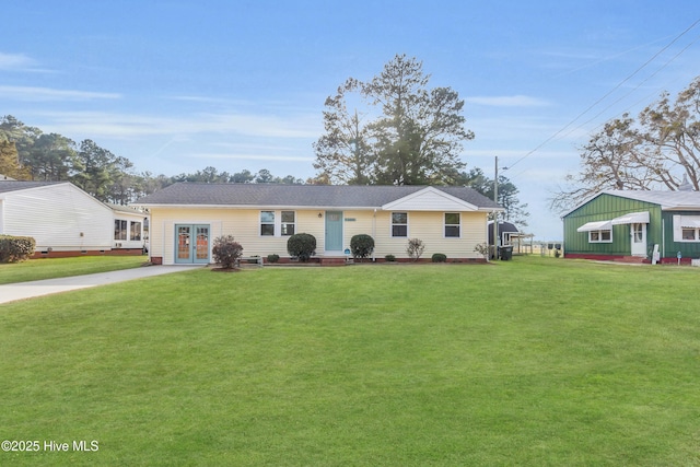 ranch-style house with a front yard and french doors