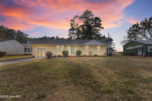 single story home featuring french doors and a yard