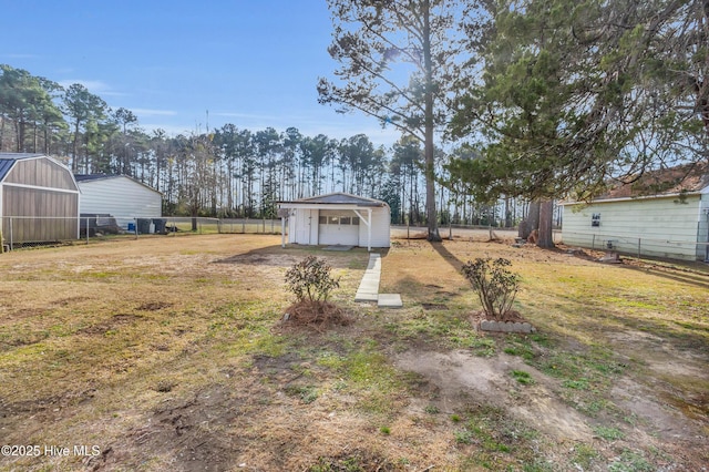 view of yard featuring an outdoor structure and a carport