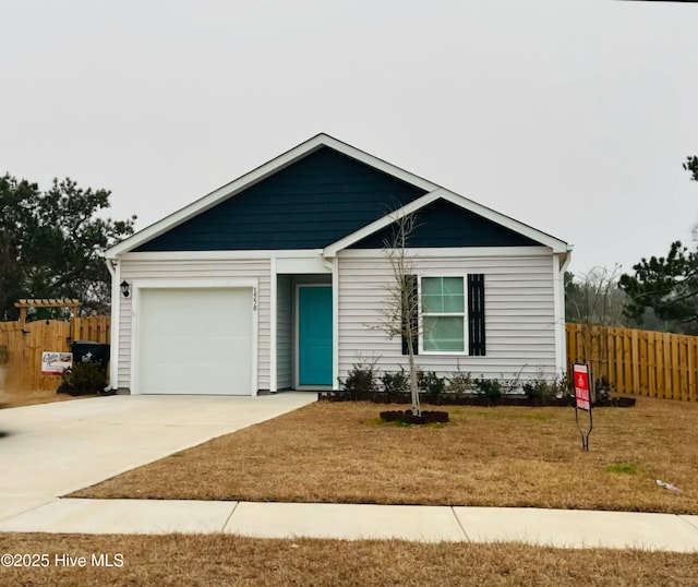 single story home featuring driveway, a garage, fence, and a front lawn