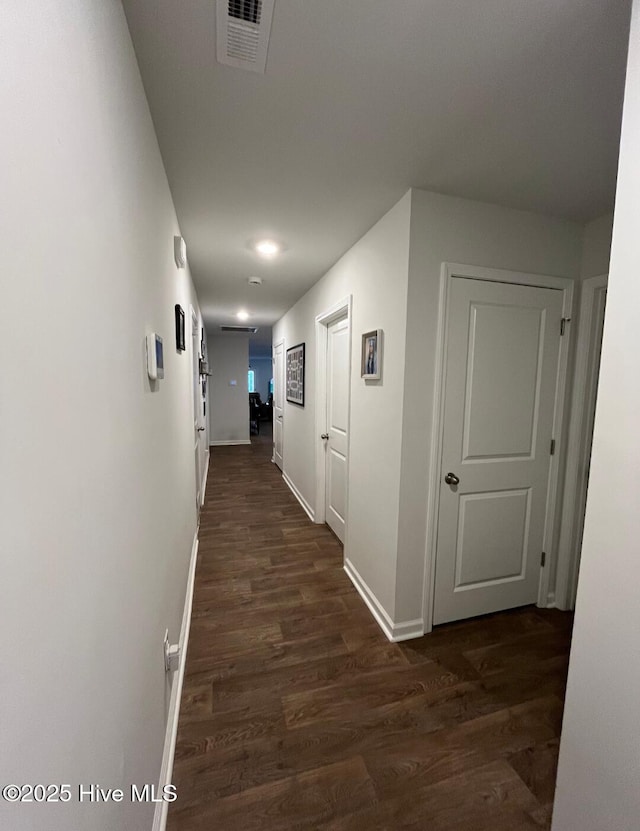 hallway with dark hardwood / wood-style flooring