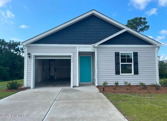 ranch-style house featuring a garage, driveway, and a front yard