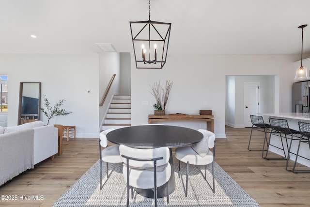 dining room featuring a chandelier and light wood-type flooring