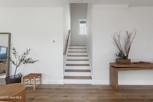 stairs featuring hardwood / wood-style flooring