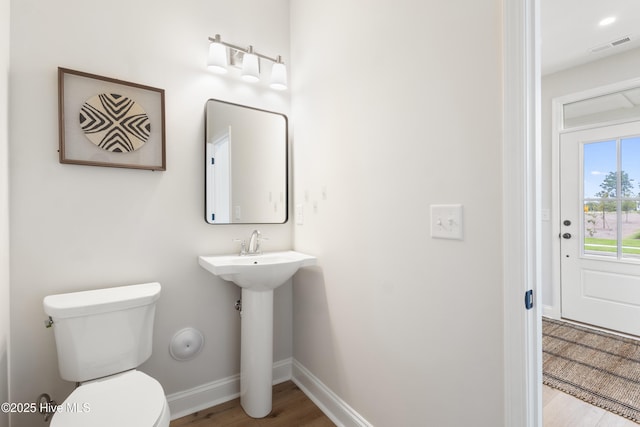 bathroom featuring hardwood / wood-style flooring, sink, and toilet