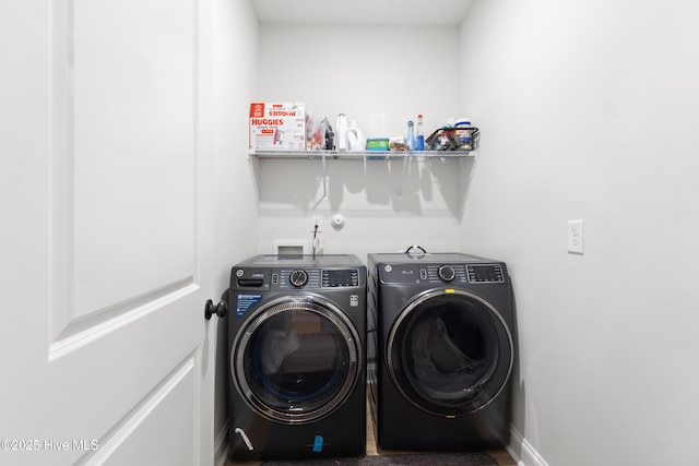 clothes washing area with washing machine and dryer