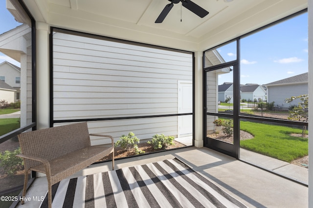 sunroom featuring ceiling fan