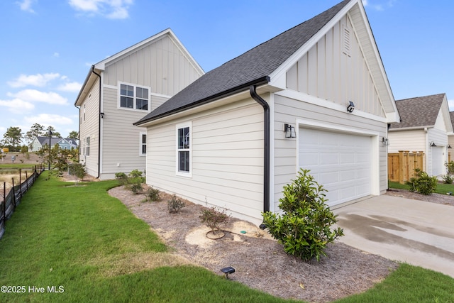 view of side of property with a garage and a lawn