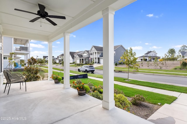 view of patio with ceiling fan and a porch