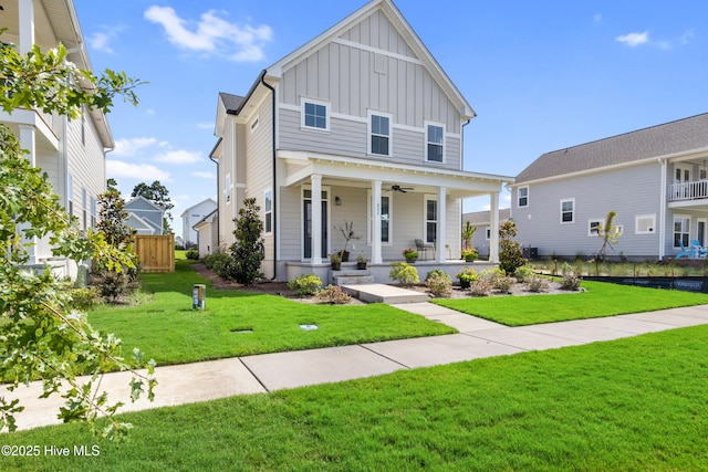 view of front of home with a front lawn, ceiling fan, and a porch