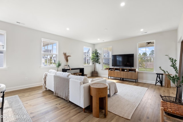 living room with plenty of natural light and light wood-type flooring