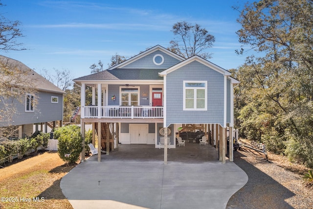 view of front of home featuring a carport, ceiling fan, and a porch