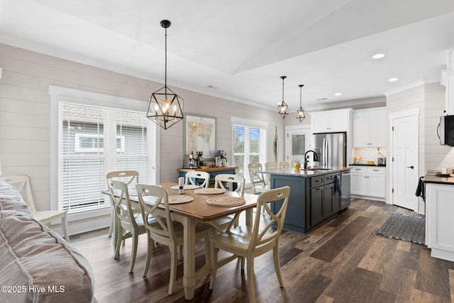 dining space featuring lofted ceiling, sink, and dark hardwood / wood-style floors