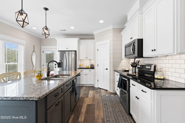 kitchen with white cabinetry, sink, decorative light fixtures, and appliances with stainless steel finishes