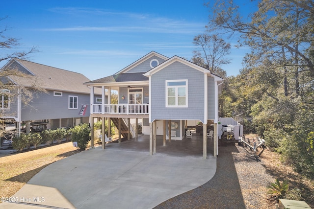 back of house featuring a carport and a porch